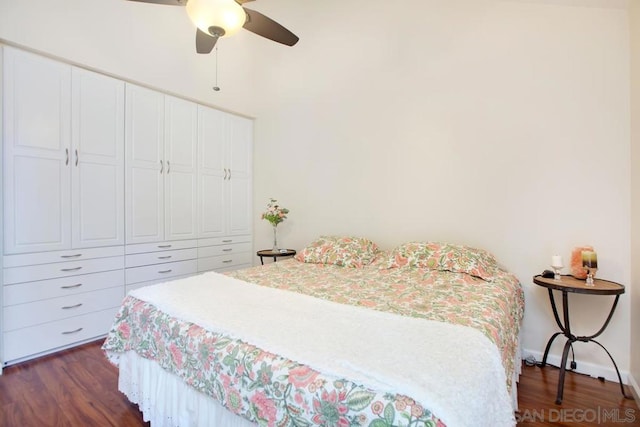 bedroom with dark wood-type flooring, ceiling fan, and a closet