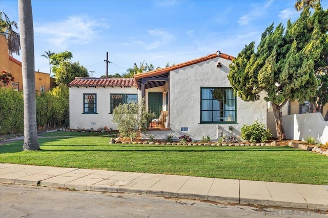 mediterranean / spanish house featuring a front yard