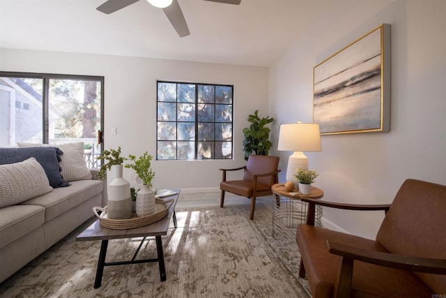 living room featuring wood-type flooring and ceiling fan