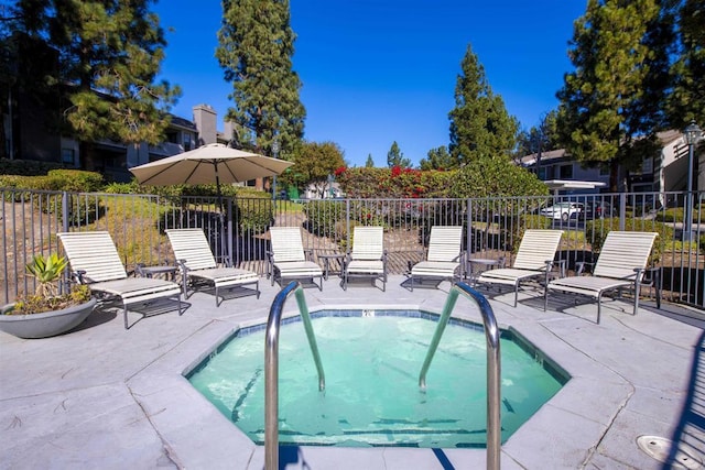 view of pool with a hot tub