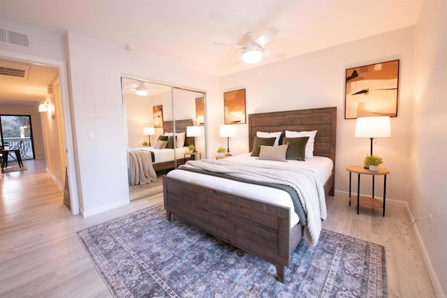 bedroom featuring ceiling fan, light hardwood / wood-style floors, and a closet