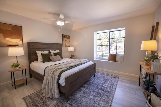 bedroom with ceiling fan and light wood-type flooring