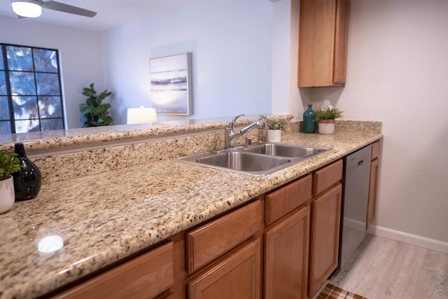 kitchen with ceiling fan, dishwasher, sink, and light hardwood / wood-style flooring