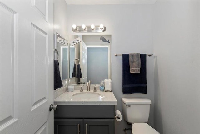 bathroom featuring toilet and vanity