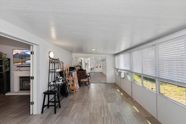 sunroom / solarium with cooling unit and a fireplace