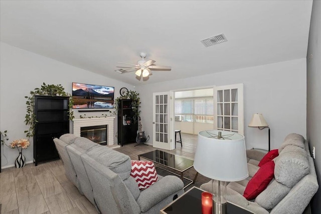 living room with french doors, ceiling fan, and light hardwood / wood-style flooring