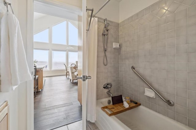 bathroom with shower / bath combo with shower curtain