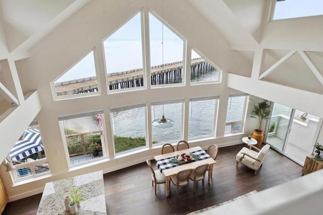 sunroom / solarium featuring ceiling fan and a water view