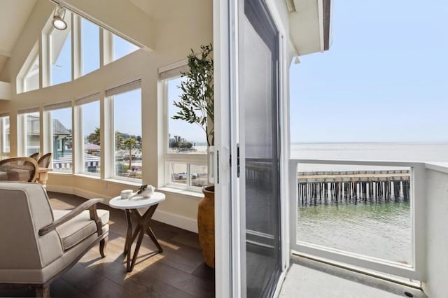 sunroom featuring a water view