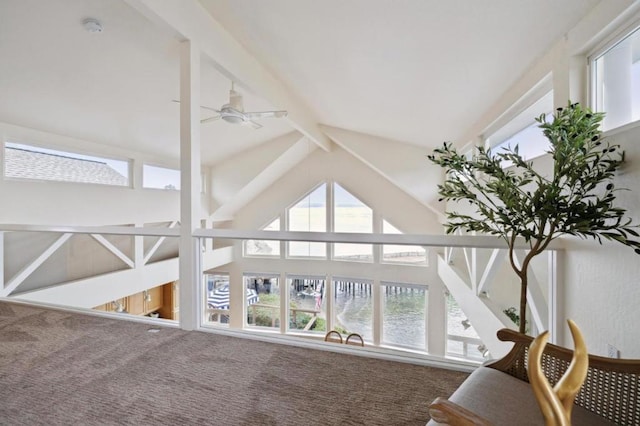 interior details with ceiling fan, a water view, and beamed ceiling