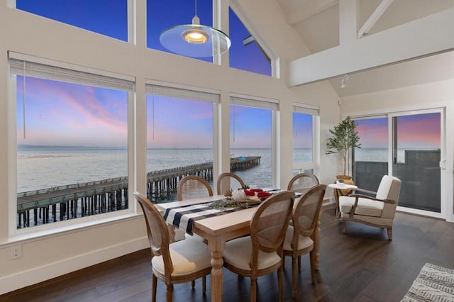 sunroom with a water view and vaulted ceiling