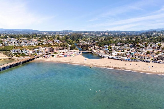 drone / aerial view with a water view and a beach view