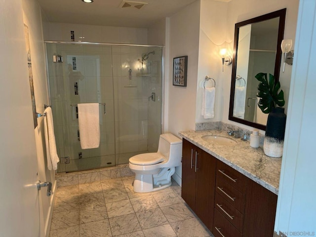 bathroom with a shower with shower door, toilet, and vanity