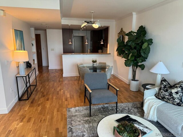 living room featuring crown molding and light hardwood / wood-style floors