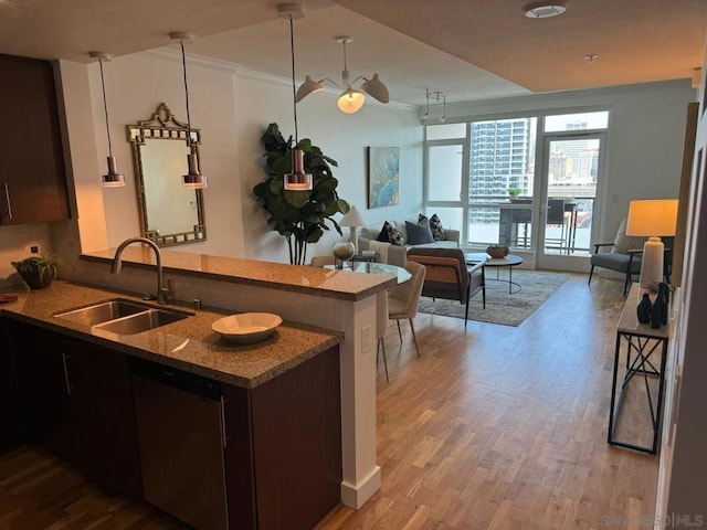 kitchen featuring light hardwood / wood-style floors, stainless steel dishwasher, kitchen peninsula, sink, and crown molding