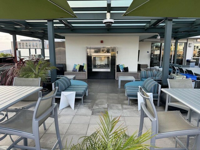 view of patio / terrace with an outdoor living space with a fireplace