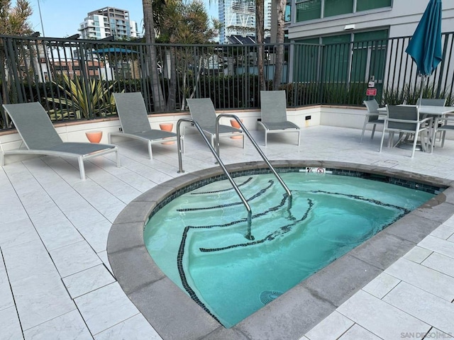 view of pool with a community hot tub and a patio