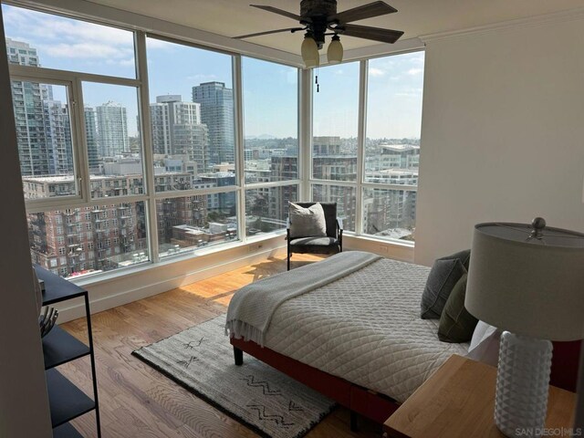 bedroom with ceiling fan and hardwood / wood-style flooring