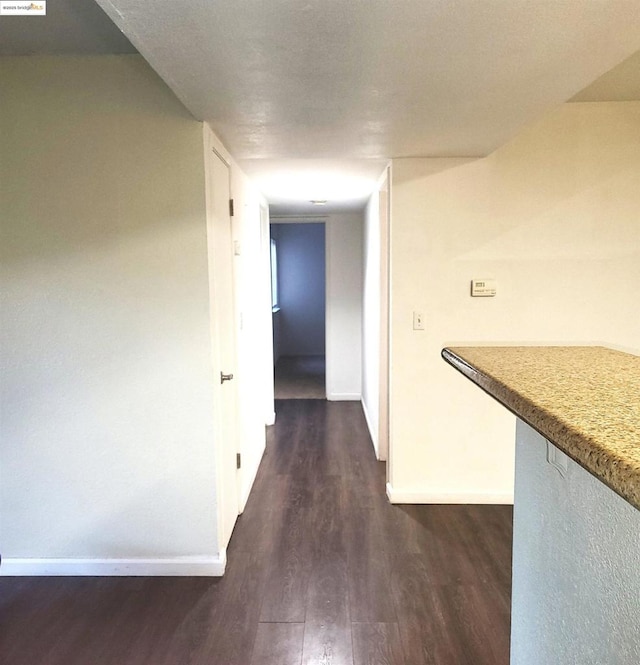 hallway featuring dark wood-type flooring