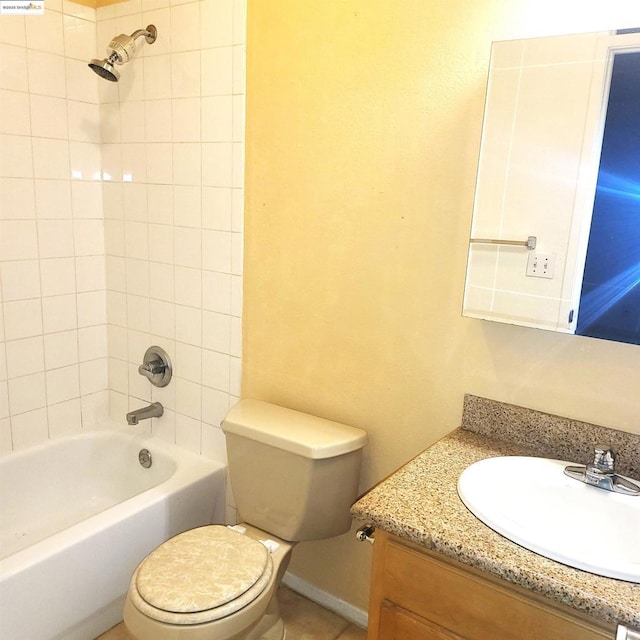 full bathroom with toilet, tiled shower / bath combo, and vanity