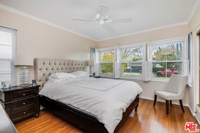 bedroom featuring light wood-type flooring, ceiling fan, ornamental molding, and multiple windows