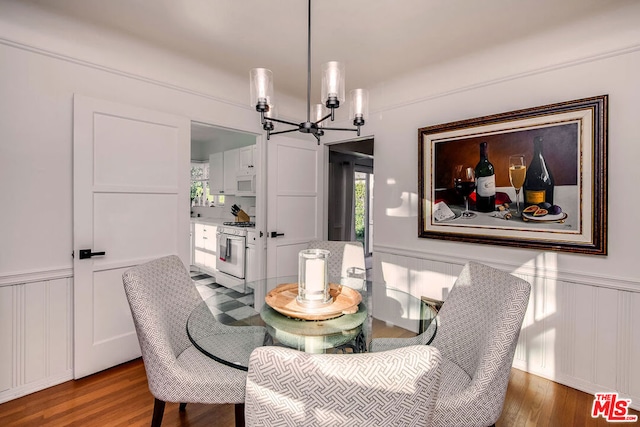 dining area featuring hardwood / wood-style flooring and a notable chandelier