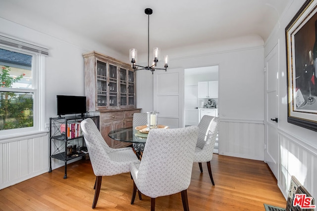 dining room featuring an inviting chandelier and light hardwood / wood-style floors