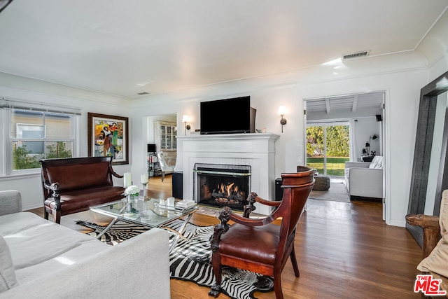 living room featuring a brick fireplace and hardwood / wood-style floors