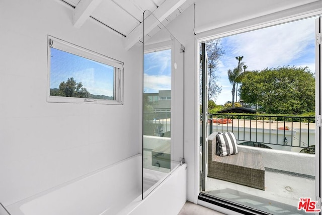 doorway featuring a water view and beamed ceiling