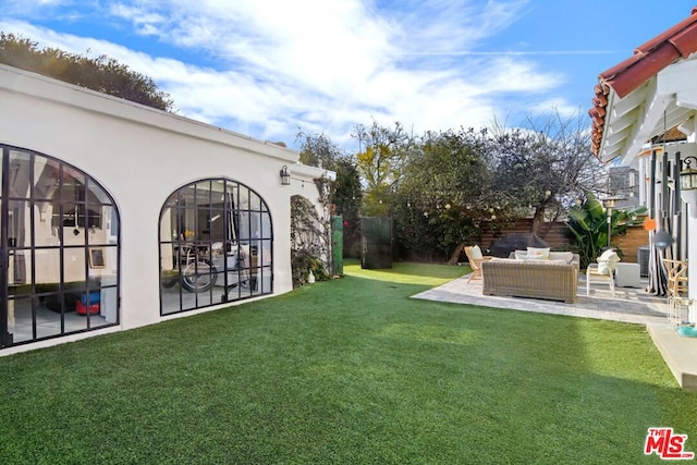 view of yard with a patio area and an outdoor living space