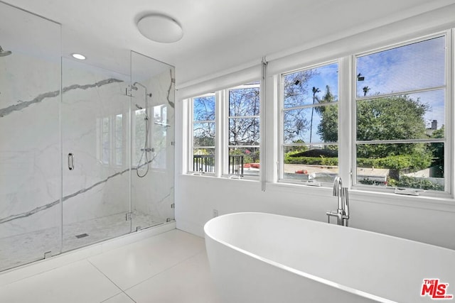 bathroom featuring shower with separate bathtub, tile patterned floors, and plenty of natural light