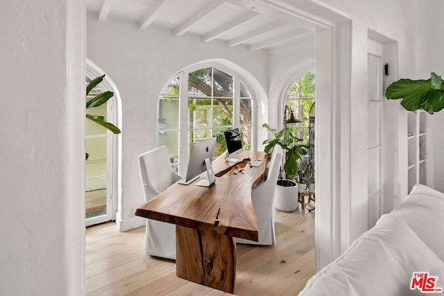 office area featuring light hardwood / wood-style floors and beam ceiling