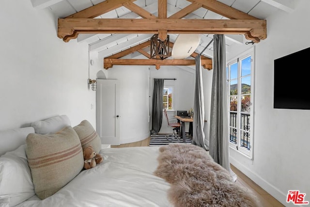 bedroom featuring multiple windows and lofted ceiling with beams