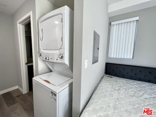 washroom with stacked washing maching and dryer, light hardwood / wood-style flooring, and electric panel