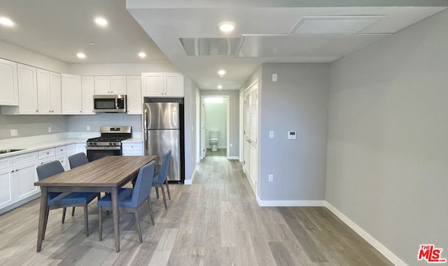 kitchen featuring light hardwood / wood-style floors, sink, white cabinetry, and stainless steel appliances