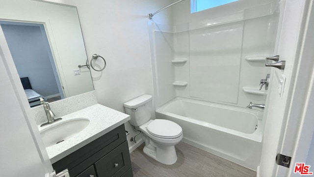 full bathroom featuring hardwood / wood-style flooring, tub / shower combination, toilet, and vanity