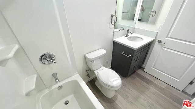 full bathroom with toilet, shower / bathtub combination, wood-type flooring, and vanity