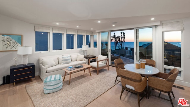 living room featuring a water view and hardwood / wood-style flooring