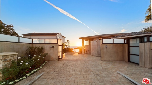 view of patio terrace at dusk