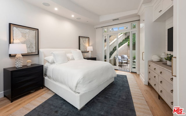 bedroom with access to exterior and light wood-type flooring