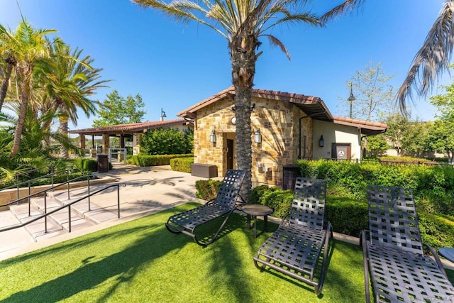 rear view of property with a patio area and a yard