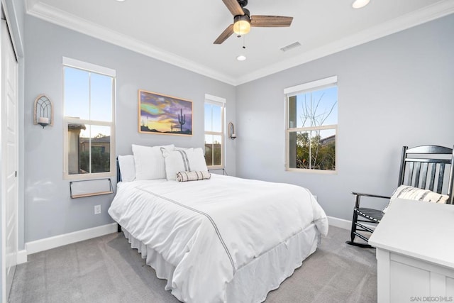 carpeted bedroom with ceiling fan and ornamental molding