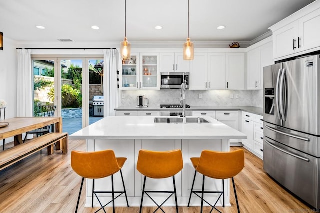 kitchen with appliances with stainless steel finishes, decorative backsplash, and white cabinetry