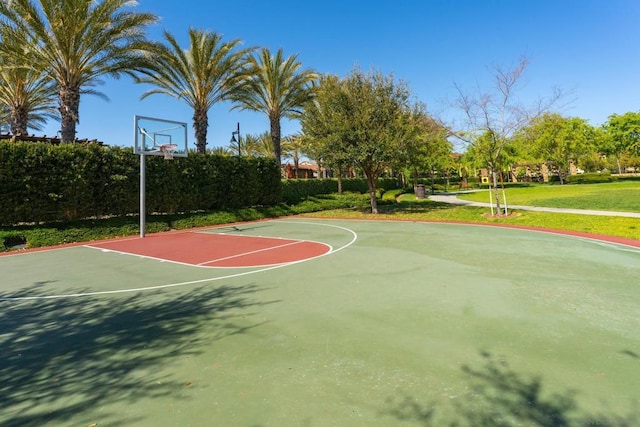 view of basketball court with a yard