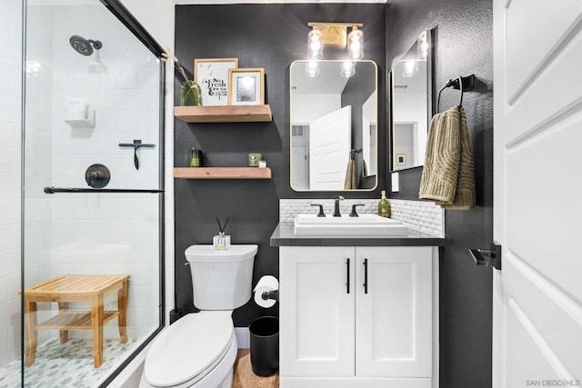 bathroom with tasteful backsplash, vanity, toilet, and a shower with shower door