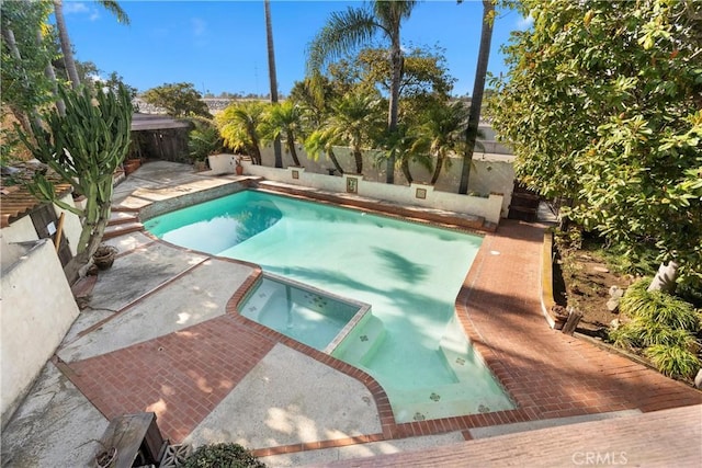 view of pool with an in ground hot tub and a patio area