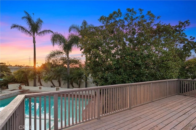 pool at dusk with a deck