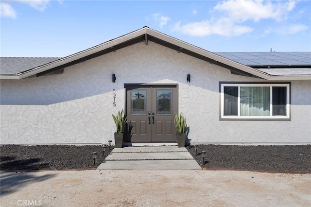 doorway to property featuring solar panels and french doors