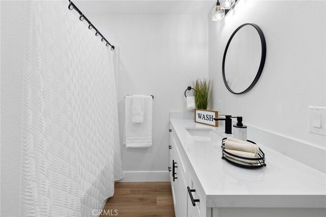 bathroom featuring vanity and hardwood / wood-style floors