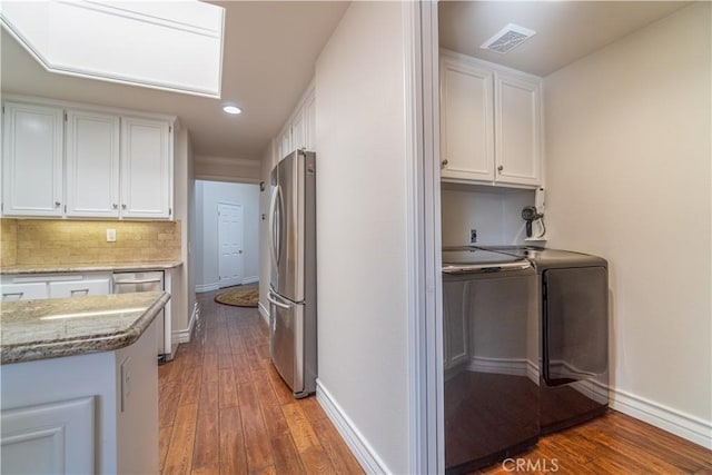 interior space with washer and clothes dryer and hardwood / wood-style floors